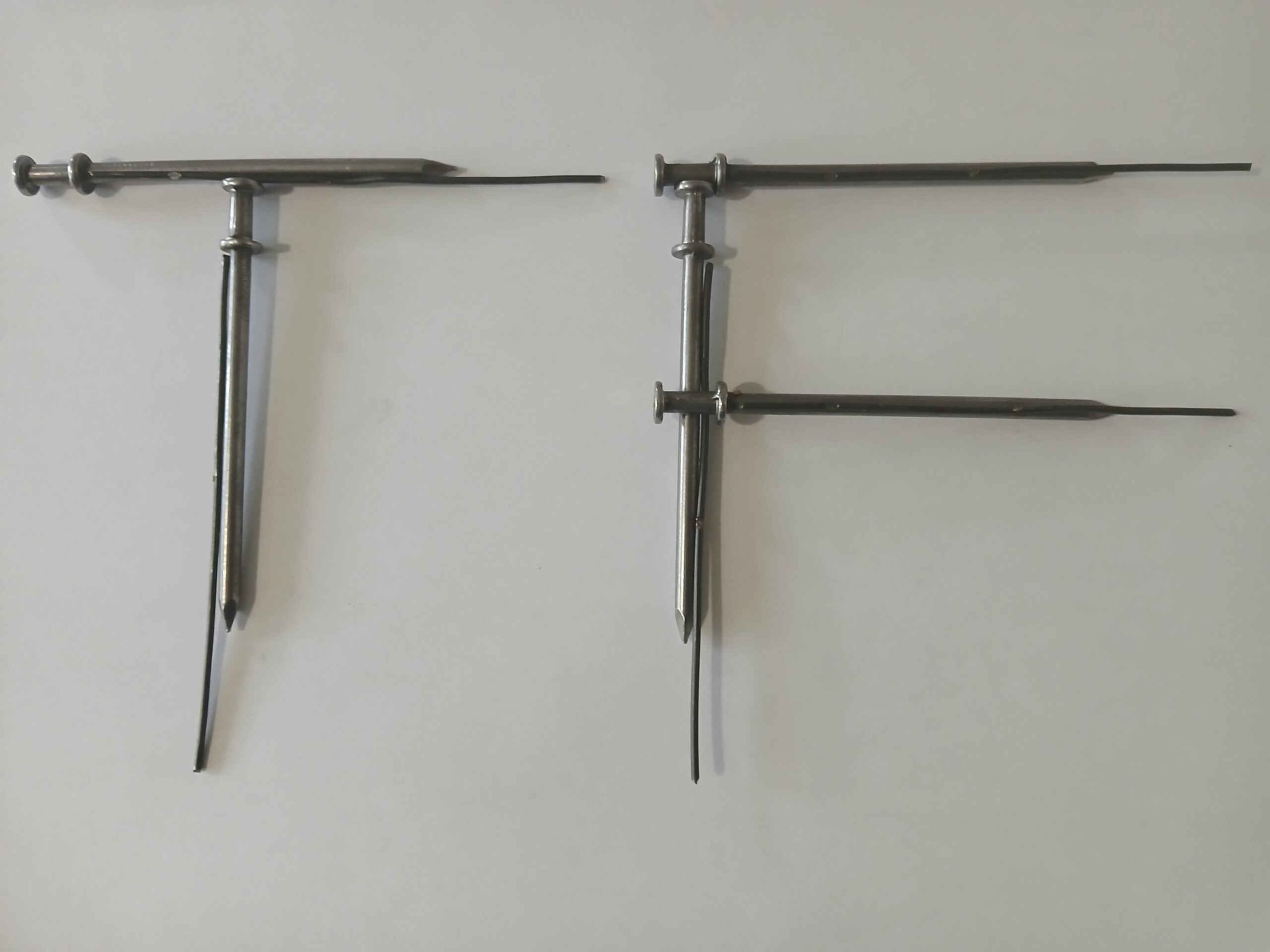 Two metal calipers arranged in a 'T' and an 'F' shape, to represent the initials of "TempFast"